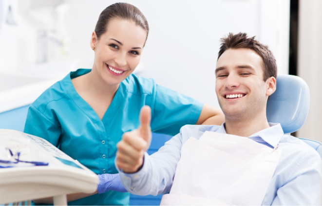 dental-assistant-with-happy-patient-in-dental-chiar